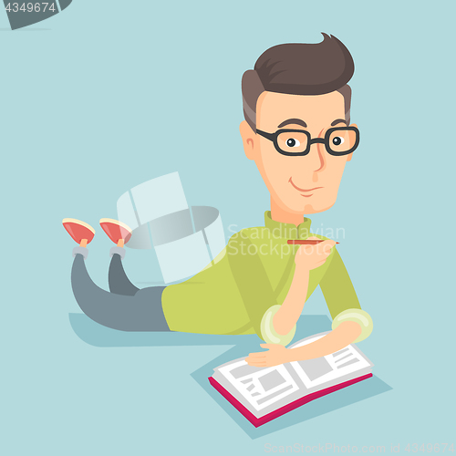 Image of Student laying on the floor and reading book.