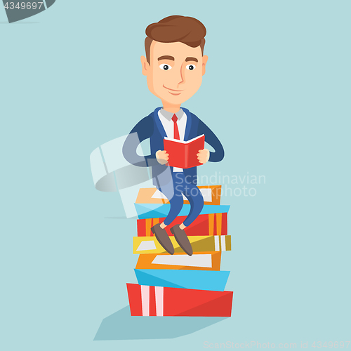 Image of Student sitting on huge pile of books.