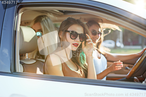 Image of young women in the car smiling