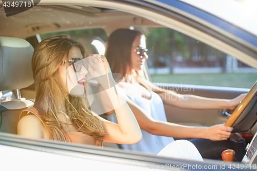 Image of young women in the car smiling