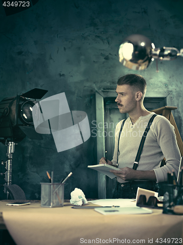 Image of Architect working on drawing table in office