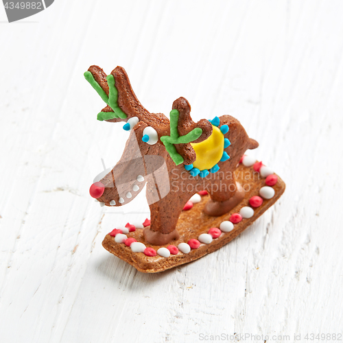 Image of gingerbread deer on white wooden table