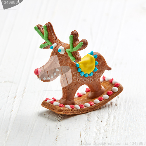Image of gingerbread deer on white wooden table