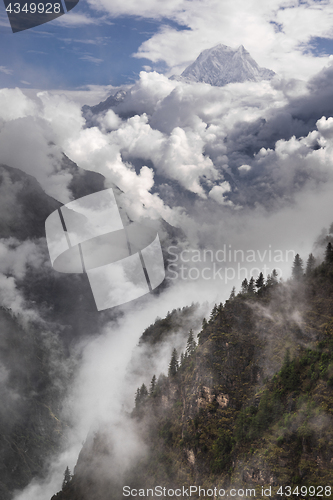 Image of Nilgiri mountain peak and cloudy Himalayas