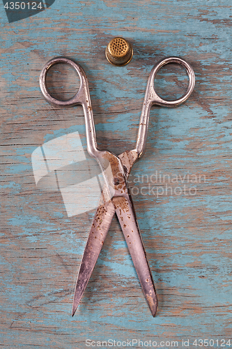 Image of Retro sewing accessories on blue wooden background