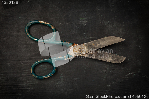 Image of Vintage scissors on black wooden background