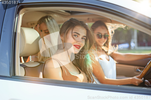 Image of young women in the car smiling