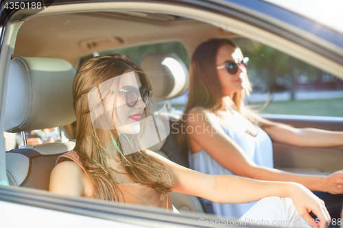 Image of young women in the car smiling
