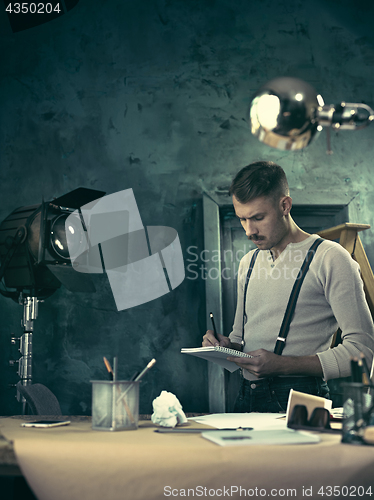 Image of Architect working on drawing table in office