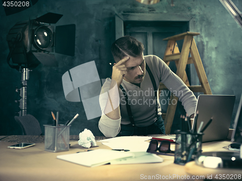 Image of Architect working on drawing table in office