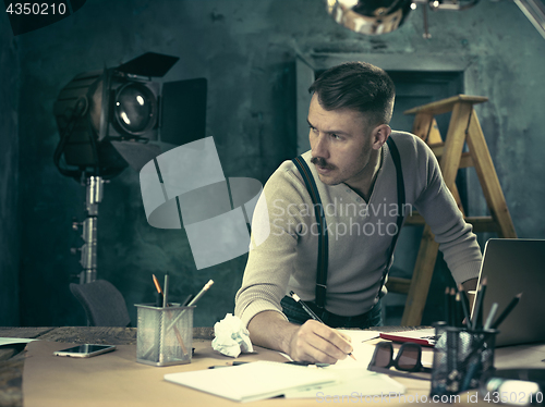 Image of Architect working on drawing table in office