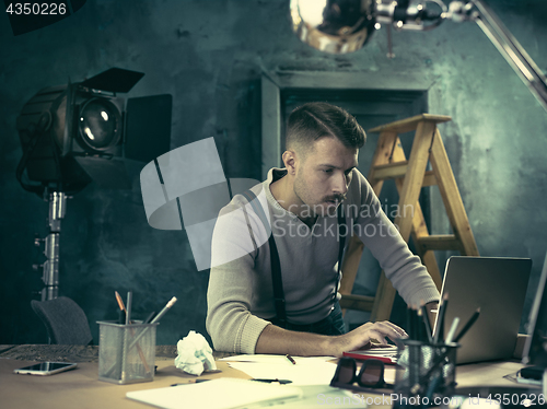 Image of Architect working on drawing table in office