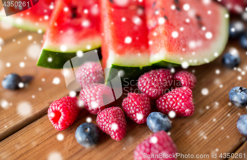 Image of close up of fruits and berries on wooden table