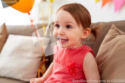 Image of happy baby girl on birthday party at home