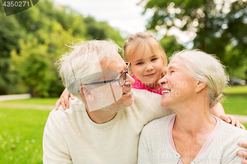 Image of senior grandparents and granddaughter at park