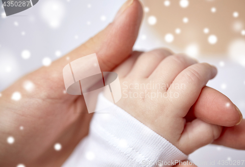 Image of close up of mother and newborn baby hands