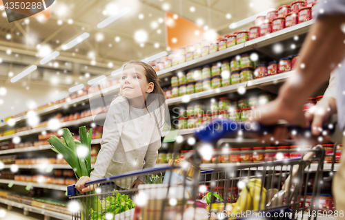 Image of child with father buying food at grocery store