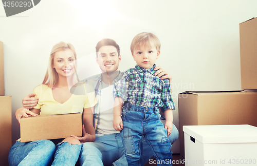 Image of happy family with boxes moving to new home