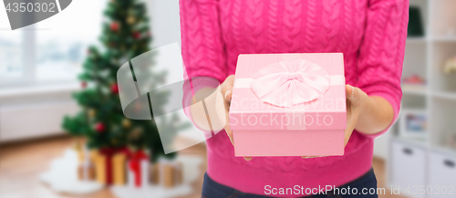 Image of close up of woman hands holding christmas gift