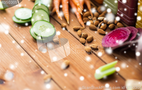 Image of different vegetables and almond nuts on wood