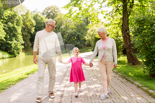 Image of senior grandparents and granddaughter at park