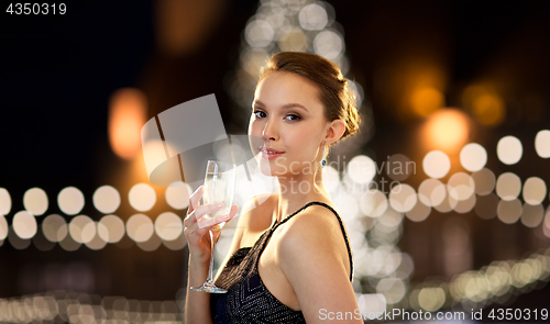 Image of young asian woman drinking champagne at christmas