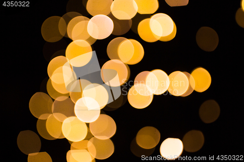Image of blurred golden lights over dark background