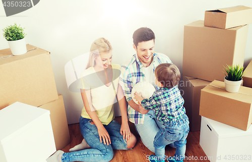 Image of happy family moving to new home and playing ball