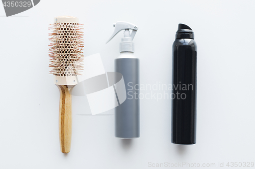 Image of styling hair sprays and curling brush