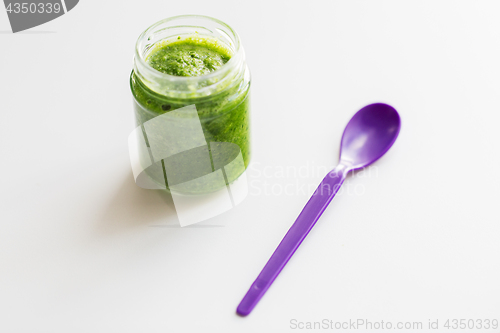 Image of jar of vegetable puree or baby food and spoon