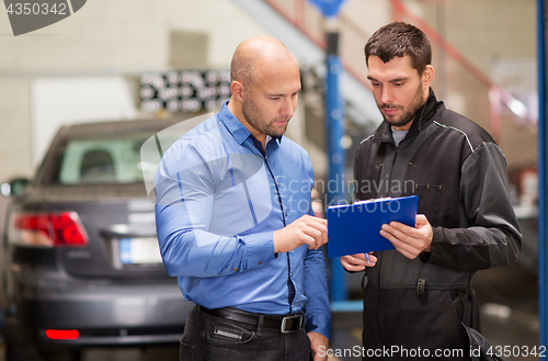 Image of auto mechanic and customer at car shop