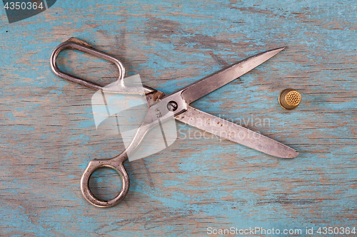 Image of Retro sewing accessories on blue wooden background