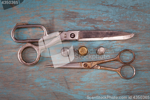 Image of Retro sewing accessories on blue wooden background