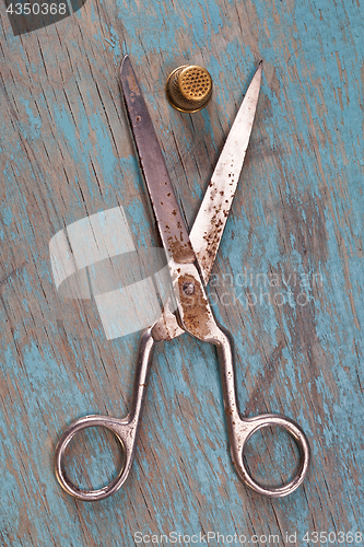 Image of Retro sewing accessories on blue wooden background