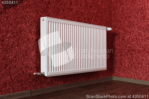 Image of white radiator in red room