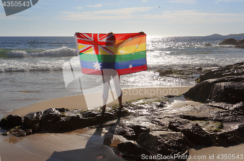 Image of Female holding an Australian flag in rainbow colours