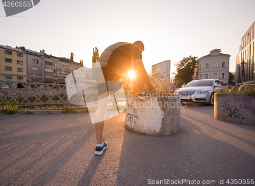 Image of man tying running shoes laces