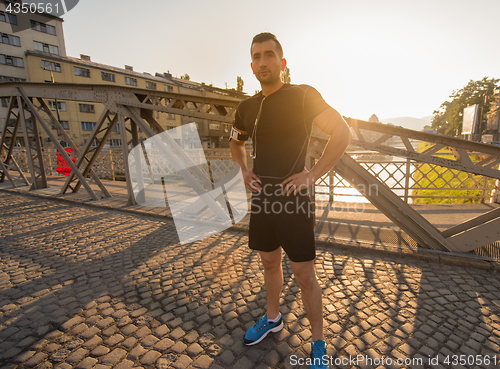 Image of portrait of a jogging man at sunny morning