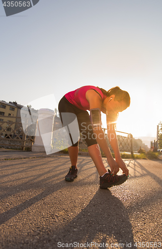 Image of athlete woman warming up and stretching