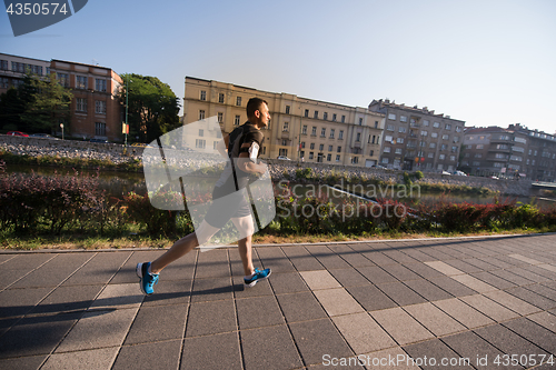 Image of man jogging at sunny morning