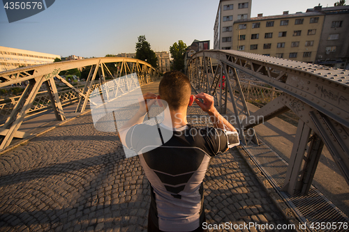 Image of portrait of a jogging man at sunny morning