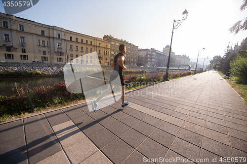 Image of man jogging at sunny morning