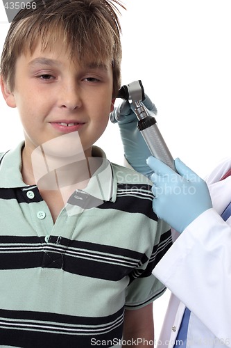 Image of Doctor checking boys ears