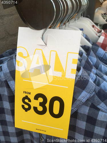 Image of Racks of shirts on sale in shop