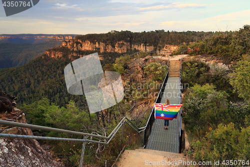 Image of Australia Said Yes Woman crossing bridge with Flag