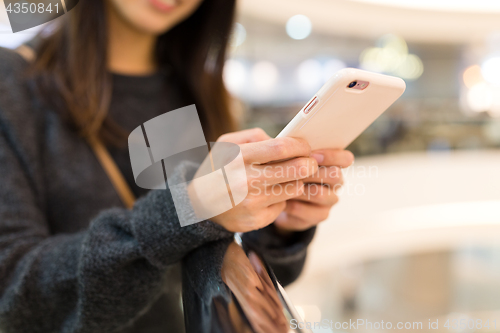 Image of Woman working on cellphone, mobile office concept