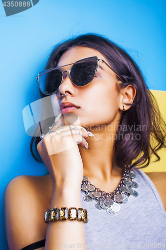 Image of lifestyle people concept. young pretty smiling indian girl with long nails wearing lot of jewelry rings, asian summer happy cool