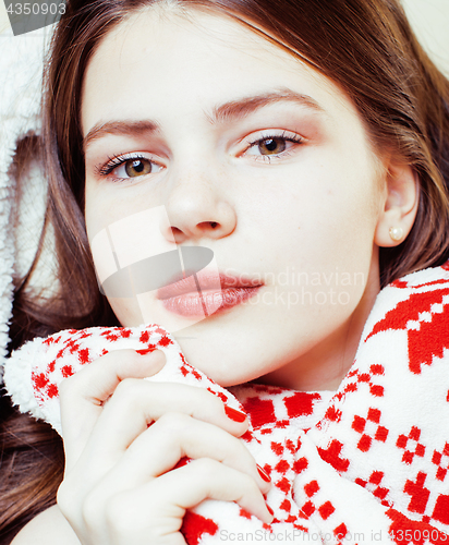 Image of young pretty real woman in sweater and winter blanket all over her face smiling at home, lifestyle people concept close up