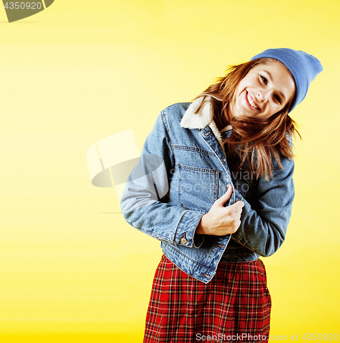 Image of lifestyle people concept: pretty young school teenage girl having fun happy smiling on yellow background 
