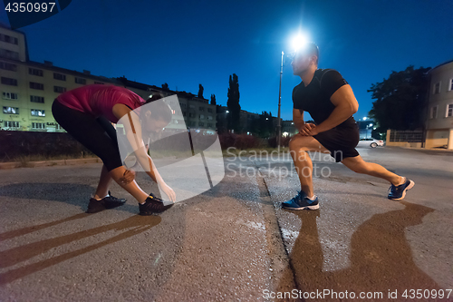 Image of couple warming up and stretching